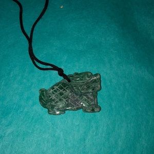 Carved jade charm on silk rope